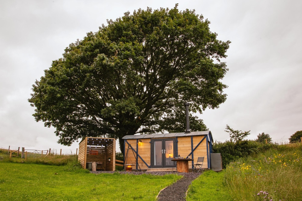 We love the passion of our hosts. Lydia &amp; Richard took the shell of this former goods wagon &amp; transformed it into a cosy Monmouthshire cubby hole. It's got a wood-fired hot tub with views across the valley &amp; an interior fir for a magazine. Find out more: bit.ly/3woZRLs