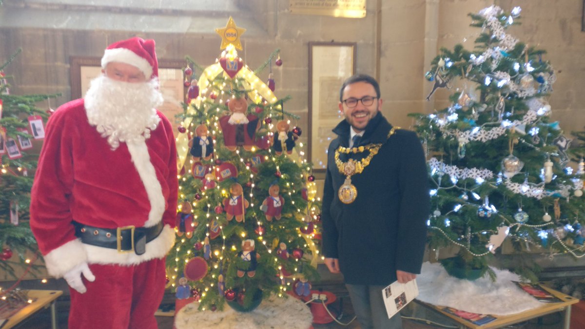 The Mayor, Councillor Richard Edgington, judging the Christmas tree competition yesterday at St Mary's church.
