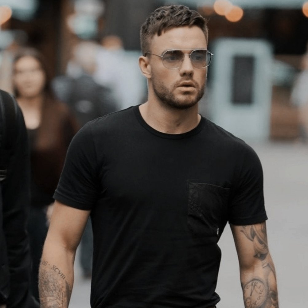 zayn malik and liam payne wearing black shirts and glasses on the streets.  that's it, that's the tweet., image size:1003x1003