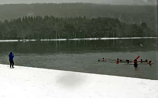 webcamsmap's tweet photo. The white stuff and freezing temperatures didn't stop a group of intrepid swimmers from taking the plunge into Loch Morlich https://t.co/p3ONH2oinN earlier today. There's always something of interest to view on real-time sceniccams around #Britain. https://t.co/YWakmk8nJK