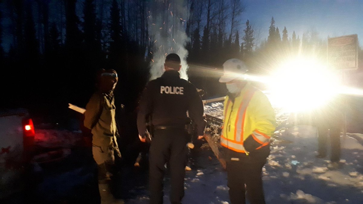 Gidimten's tweet image. Early this morning, a fire was set on the road and CGL work was stopped. Another two arrests were made on Gidimt'en territory, for a growing total of 34 arrests in the last several weeks. That makes 36 arrests since Coyote Camp was established on Sept 25th, 2021.