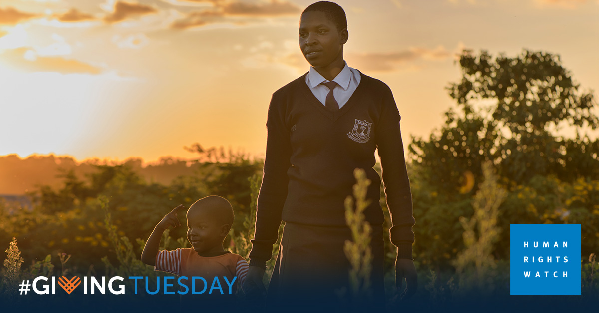 Child holds the hand of an adult, with sunset in the background. Text reads "Giving Tuesday" and Human Rights Watch logo featured.