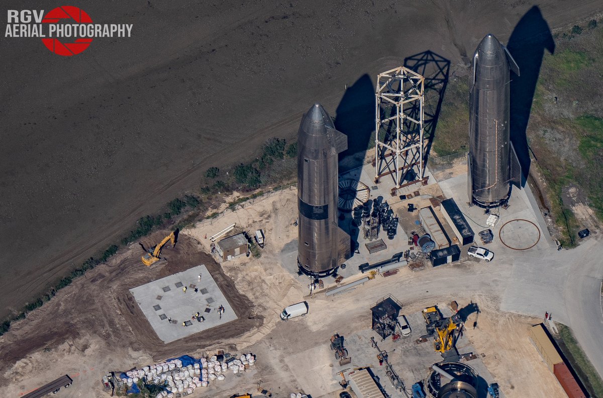 Ship 20 and 21 sit next to the new Booster stand at Starbase.