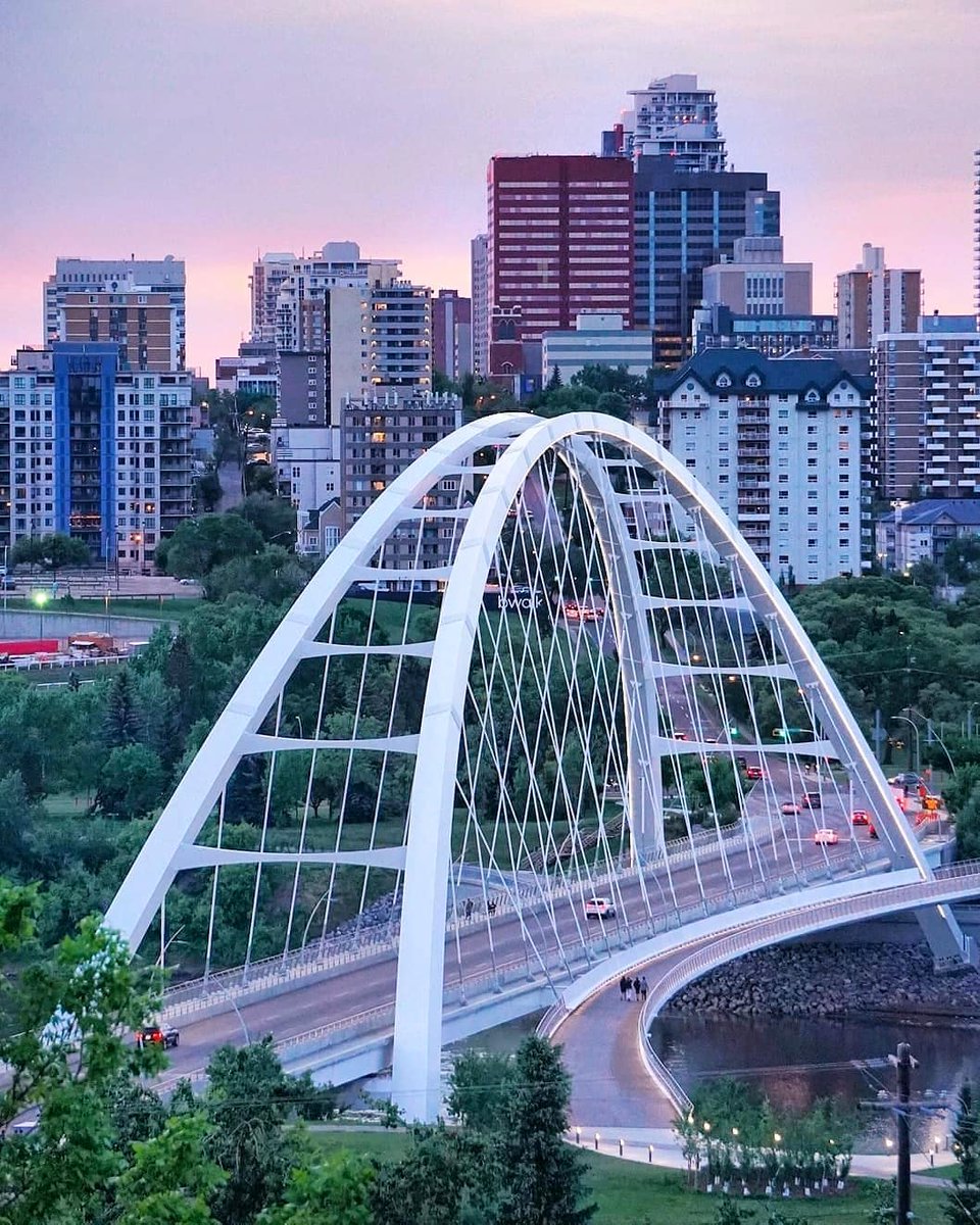 Canada's tweet photo. Summer ➡️ Winter 
 
Whether the river banks are full of green trees or covered in snow, the view of Walterdale Bridge, which was rebuilt after over 100 years, and of #Edmonton’s skyline are always beautiful! 😍 #TransformationTuesday 
📸 kimtannas &amp; capturedbybrandibee/IG https://t.co/hUzd2gWZpy