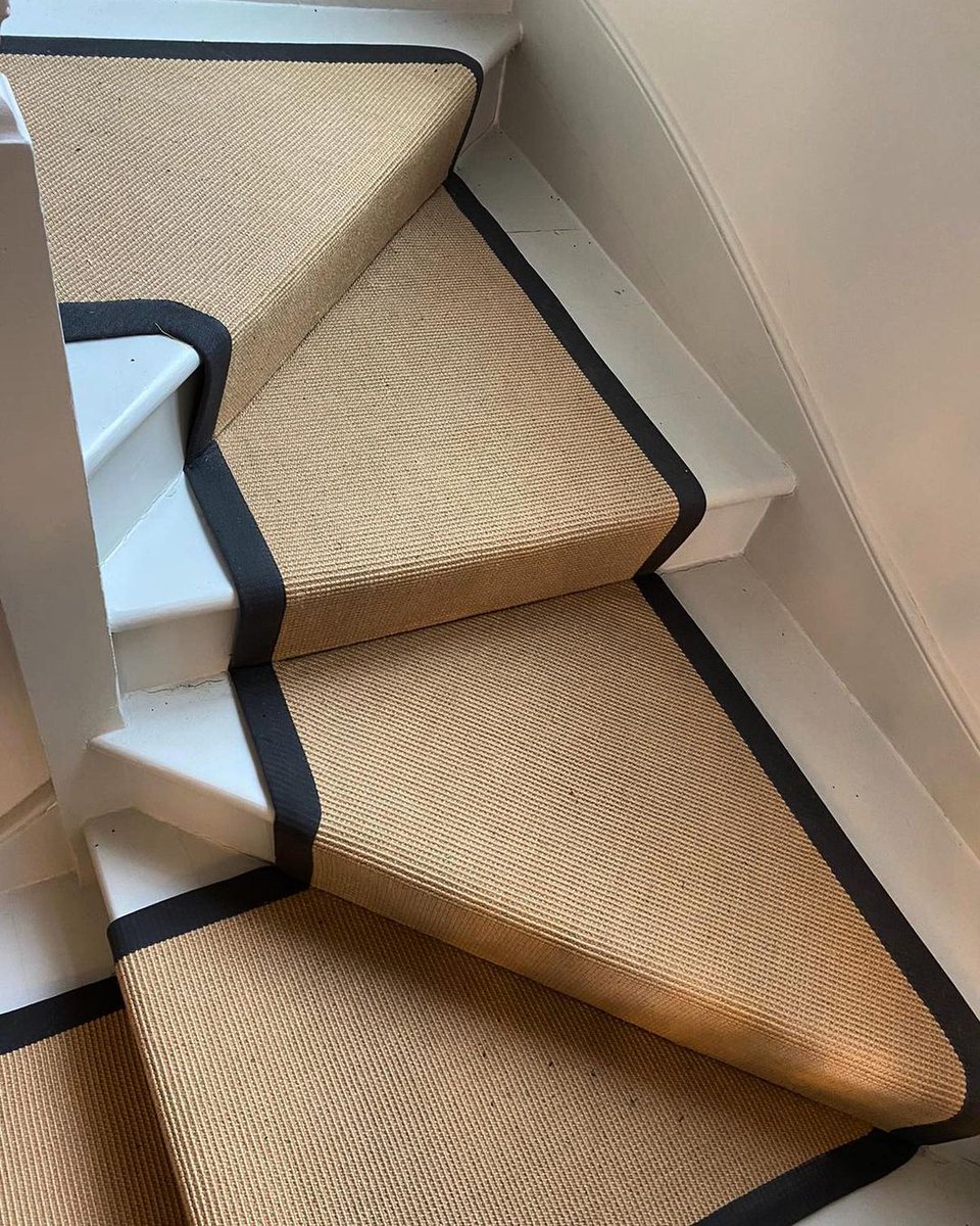It’s all in the details 😍
Elevate your home with a custom stair runner, using our range of Sisal flooring.  @bridgeflooring has used our Sisal Mini Boucle flooring in Dune, paired with black taped bounding, to create this dramatic modern design.  

Comment your thoughts below.