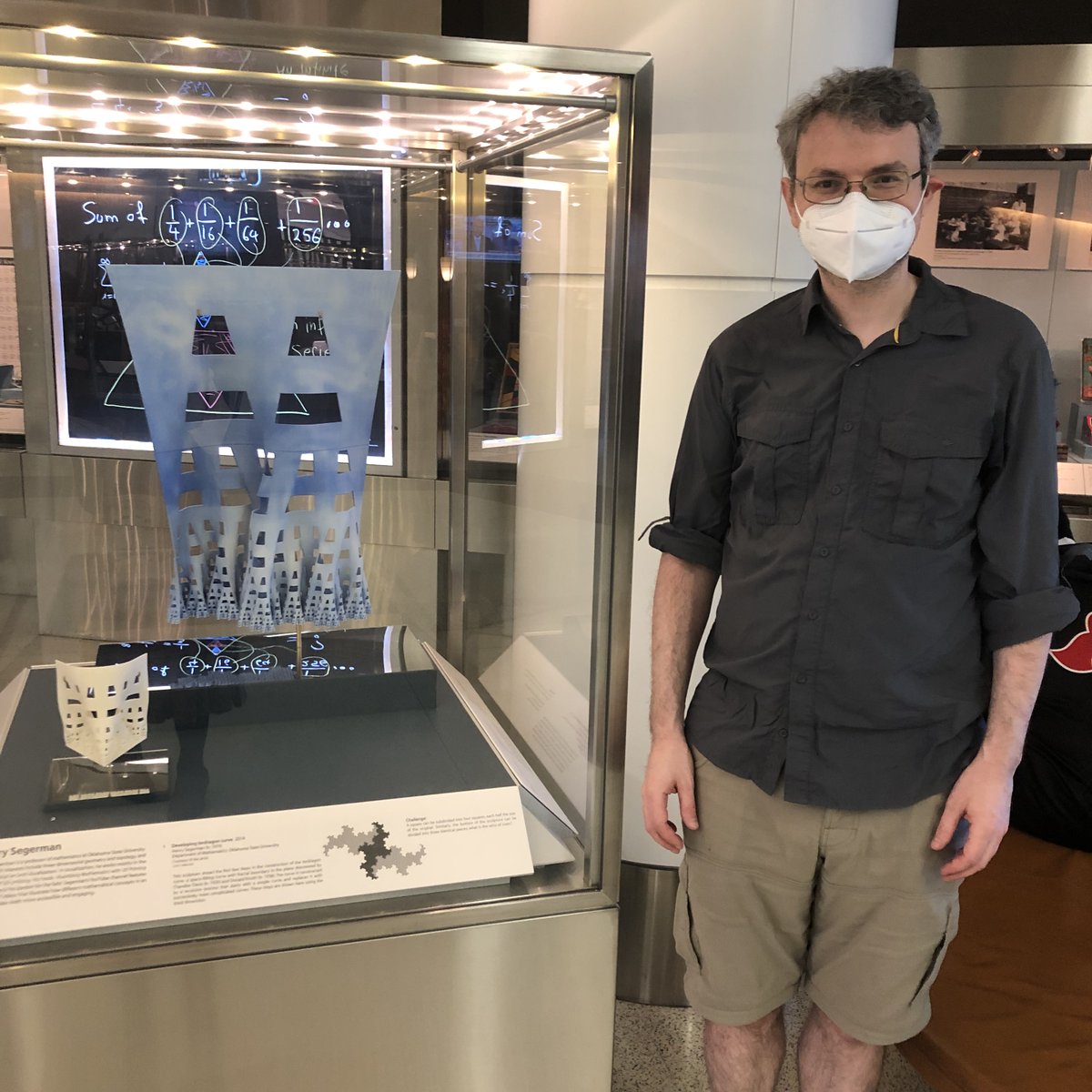 SFOMuseum's tweet photo. Henry Segerman is a professor of mathematics @OKState. His research interests include three-dimensional geometry and topology, and mathematical art and visualization. Henry visited our exhibition recently and posed for a portrait with his featured work! #mathematics #MathAtSFO https://t.co/gE4hMGVCrv