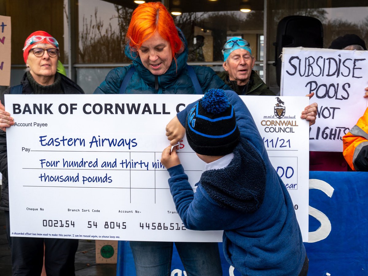 CornwallCAC's tweet photo. #SwimsNotFlights #SaveOurSwims Some of the activists pointing out that @CornwallCouncil is supporting flights to London for the same amount as it will cost to keep our swimming pools open. https://t.co/ufmKjq06V5