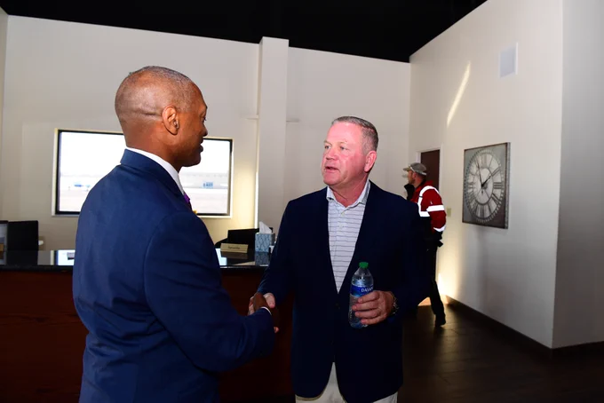 President William F. Tate IV shakes hands with new LSU football head coach Brian Kelly.