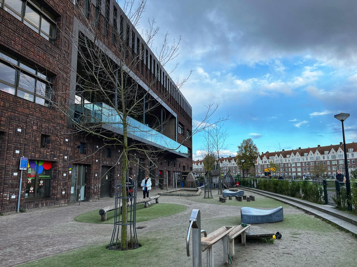 Qagggy's tweet photo. This Dutch elementary school building very conveniently has a pub with a clear view of the playground. 🍻🤸 https://t.co/3xb7ZjkZjV