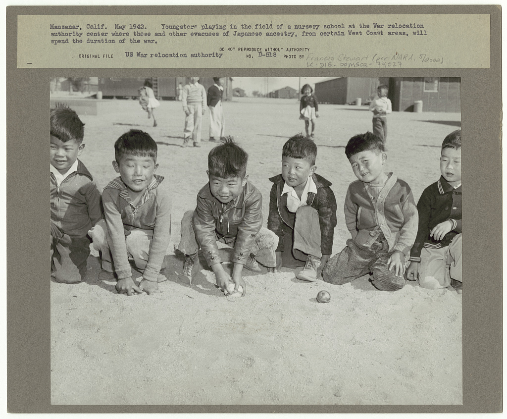 Manzanar, Calif. May 1942. Youngsters playing in the field of a nursery school at the War Relocation Authority center where these and other evacuees of Japanese ancestry, from certain West Coast areas, will spend the duration of the war (LOC) Stewart, Francis,, 1909-1992,, photographer.
