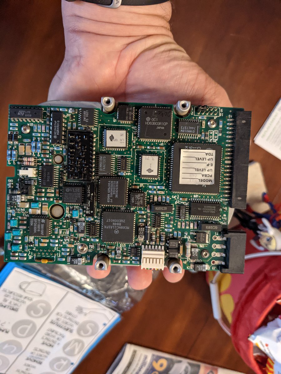 pzelnip's tweet photo. Then in same box found the old hard drive that was in that computer: a 40MB (yes, “megabyte”, not gigabyte) drive.  Pictures showing how huge it is.  Contrast with a modern Samsung SSD.  It also weighs a ton. https://t.co/8w1KJT7zEy