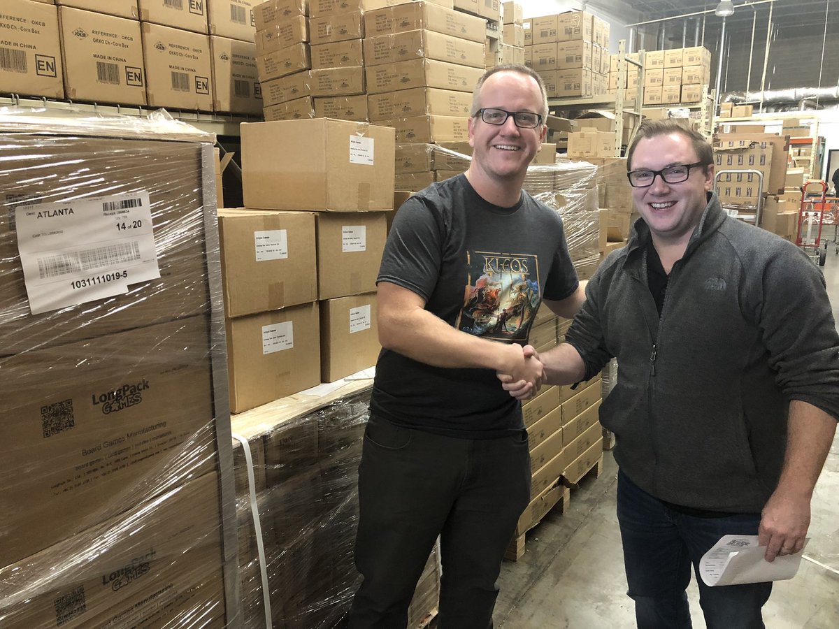 Guess what’s in those boxes behind David and I? USA Fulfillment begins Monday! Great day at Bridge Distribution and Giga Mech Games.
I’ll be at their Giga-Bites Gaming Cafe in #Marietta GA tonight and running #Kleos demos tomorrow from 2-7.  Stop by if you’re in the area! #bgg
