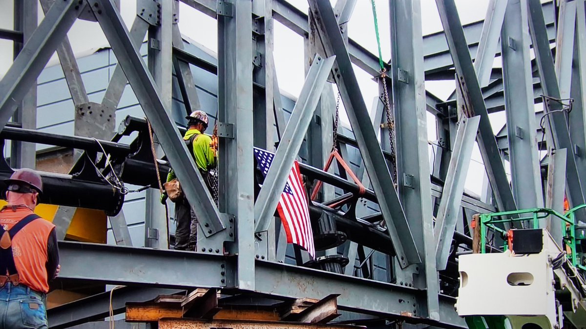 In American construction there is usually a Topping Off Ceremony where the last piece of steel is added with a flag. A ceremony seen here from The Making of Jurassic World VelociCoaster. Screenshot from Peacock streaming service. https://t.co/BtmsT7WUHR
