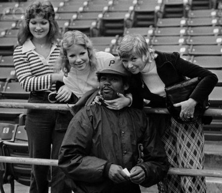PolyesterUnis's tweet photo. What's the most awesome part of this photo: The shirt on the lady at left; the pants on the lady at right; the hairdos of all three ladies; or Dock Ellis in his @Pirates #WarmupJacket? https://t.co/zBC0Iv7Xo1
