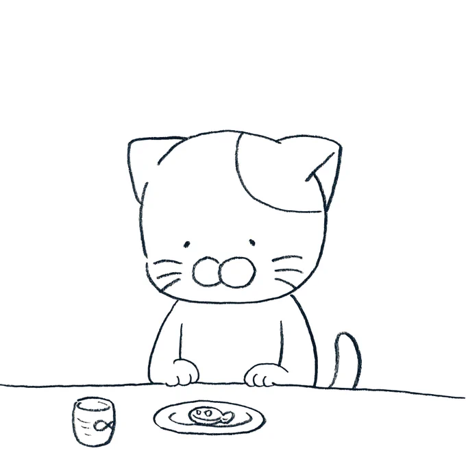 可愛いお菓子を食べる前にしばらく眺めるネコ 