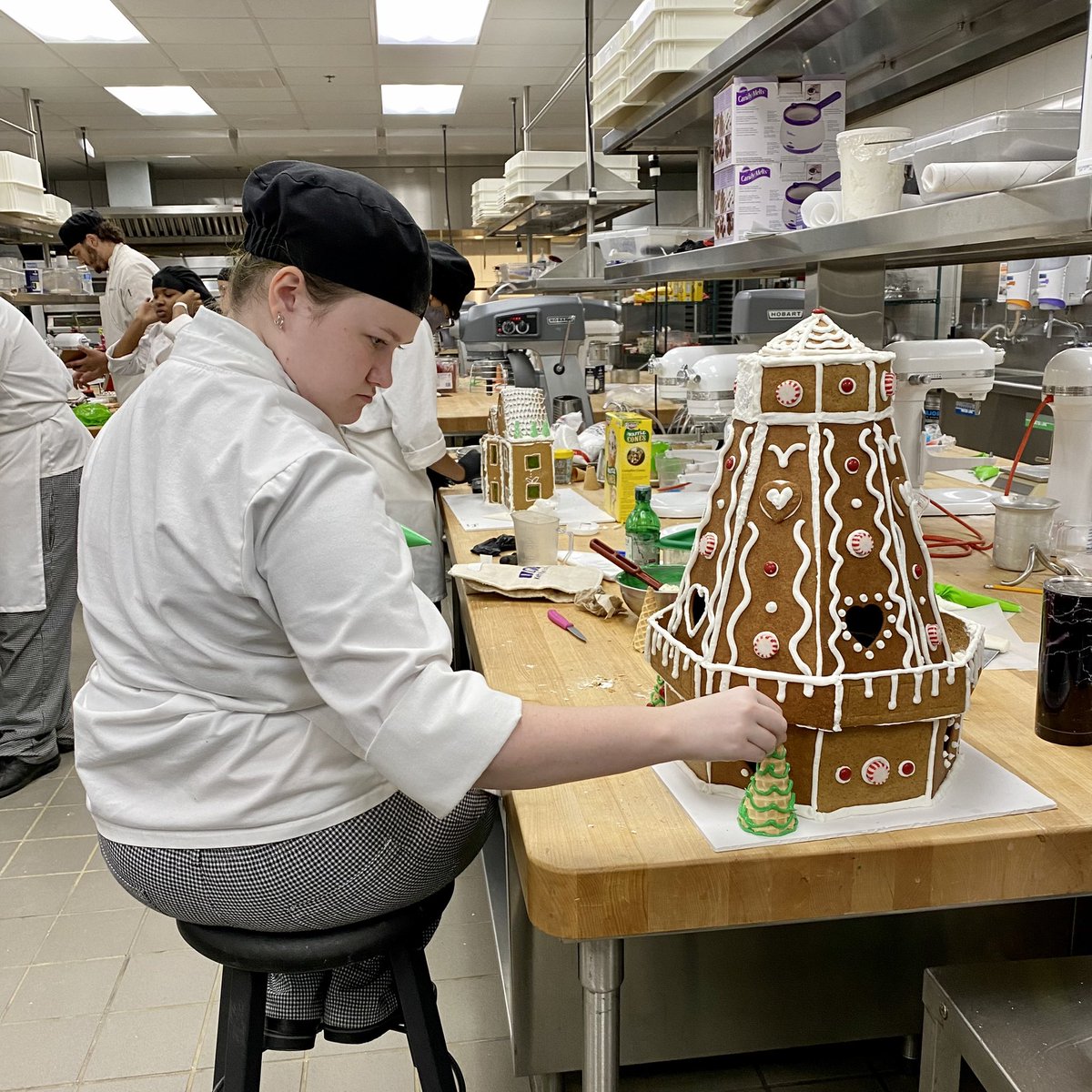 FrancisTuttle's tweet photo. It’s the most wonderful time of the year 🎶 Our #culinary students are hard at work putting the finishing touches on their #gingerbread village. Be sure to stop by the commons next week to see their amazing work! ❄️ https://t.co/WHmychoOgP