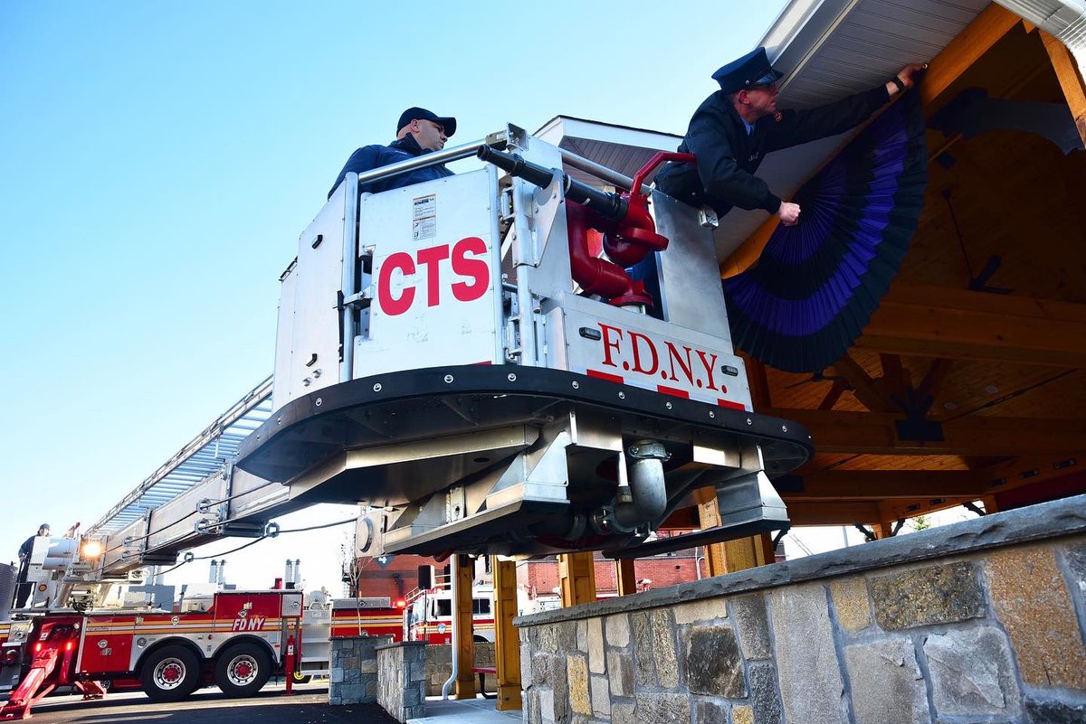 FDNY's tweet photo. FDNY Firefighters drape purple and black bunting on the exterior of the FDNY Fire Academy on Randall’s Island where Probationary Firefighter Vincent Malveaux was assigned. Read more: https://t.co/ZjL3P2jMYm https://t.co/pHJXC5QHEa