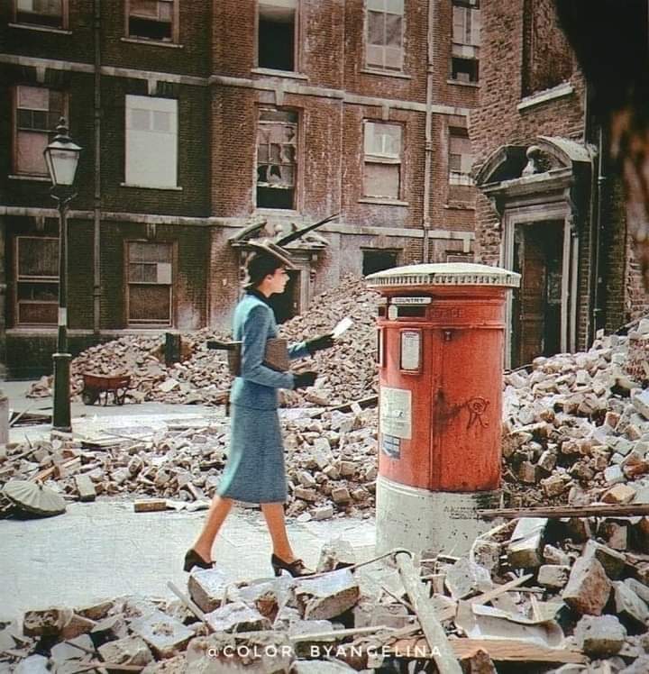 A woman posting a letter in a postbox surrounded by destroyed buildings caused by German air raids during World War II, London, UK, 1940.

#archaeohistories