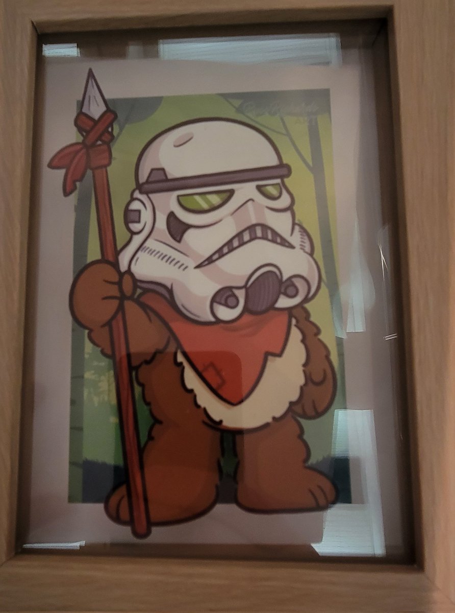 PinTraderFjorg's tweet photo. This framed Ewok in Storm Trooper helmet by @russrichardsart  is a great gift for a #StarWars fan or just your personal collection. You can also enjoy their antics in his art book "The Secret Life of Ewoks" #ECCC2021 #ECCC artist ally booth S2! https://t.co/RfExFBMWfC