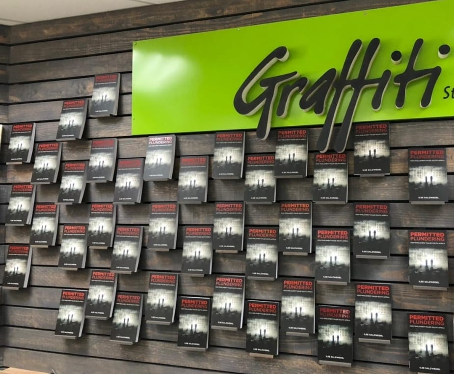A wall full of #OUTA's #PermittedPlundering by <a href="/ilsesalzwedel/">Ilse Salzwedel</a> at <a href="/Graffiti_Boeke/">Graffiti Books</a> in Pretoria. Go and get your copy today!