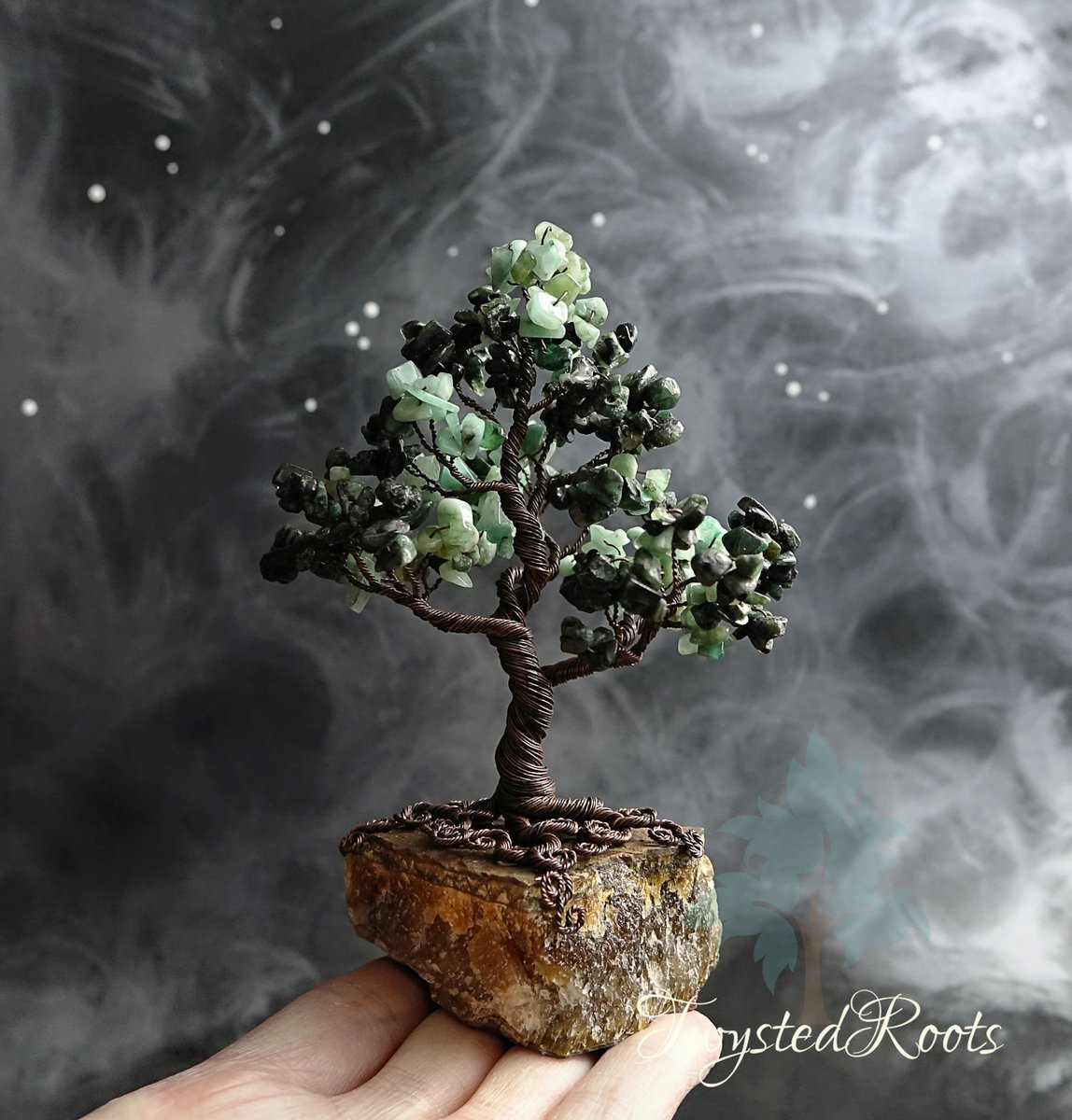 TwystedRoots's tweet photo. It's so cold I can't think of anything to say about this, other than it's a tree made of emeralds, on a tiger eye base. Oh and it's called Authenticity (since emeralds are said to be a stone of truth and love)

Send warm vibes! 🥶

#SmallBusinessSaturday #SmallBizSaturday #MHHSBD https://t.co/T3LzNFfm5q