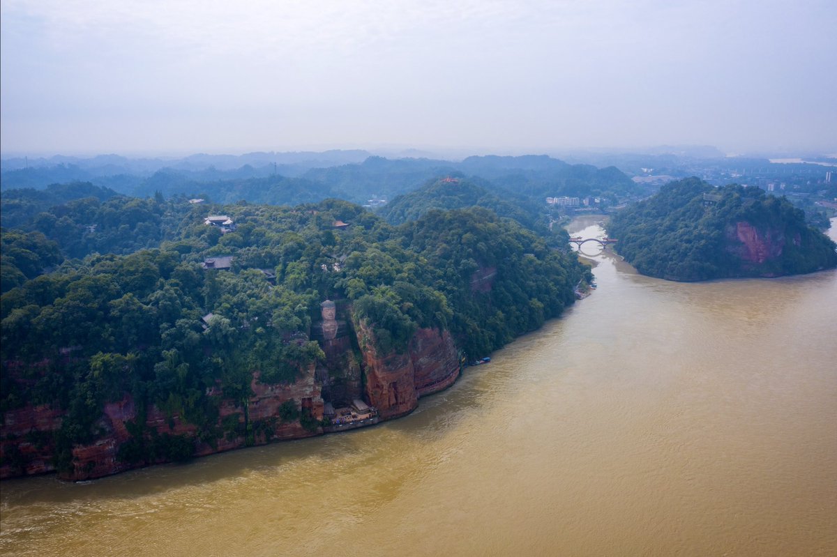 Sitting at the rushing confluence of three rivers, the Giant Buddha, a 71-meter-high one, has been guarding the passing boats from flipping over. #Leshan