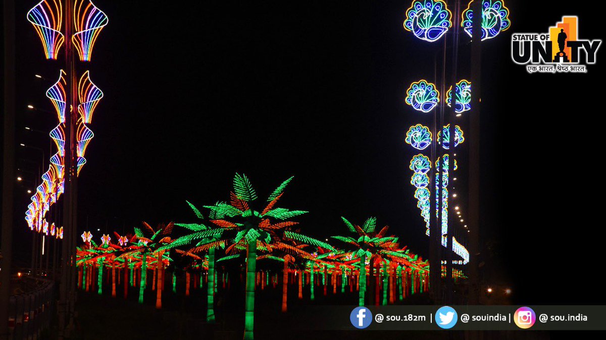 souindia's tweet photo. As the night descends on Kevadia, it comes alive with marvelous lights. This road is decked up with artistic motif lights &amp; in form of palm trees. Enjoy the splendour of night tourism with your loved ones during your visit to the world’s tallest statue at Kevadia. https://t.co/gR5DIPZTtM