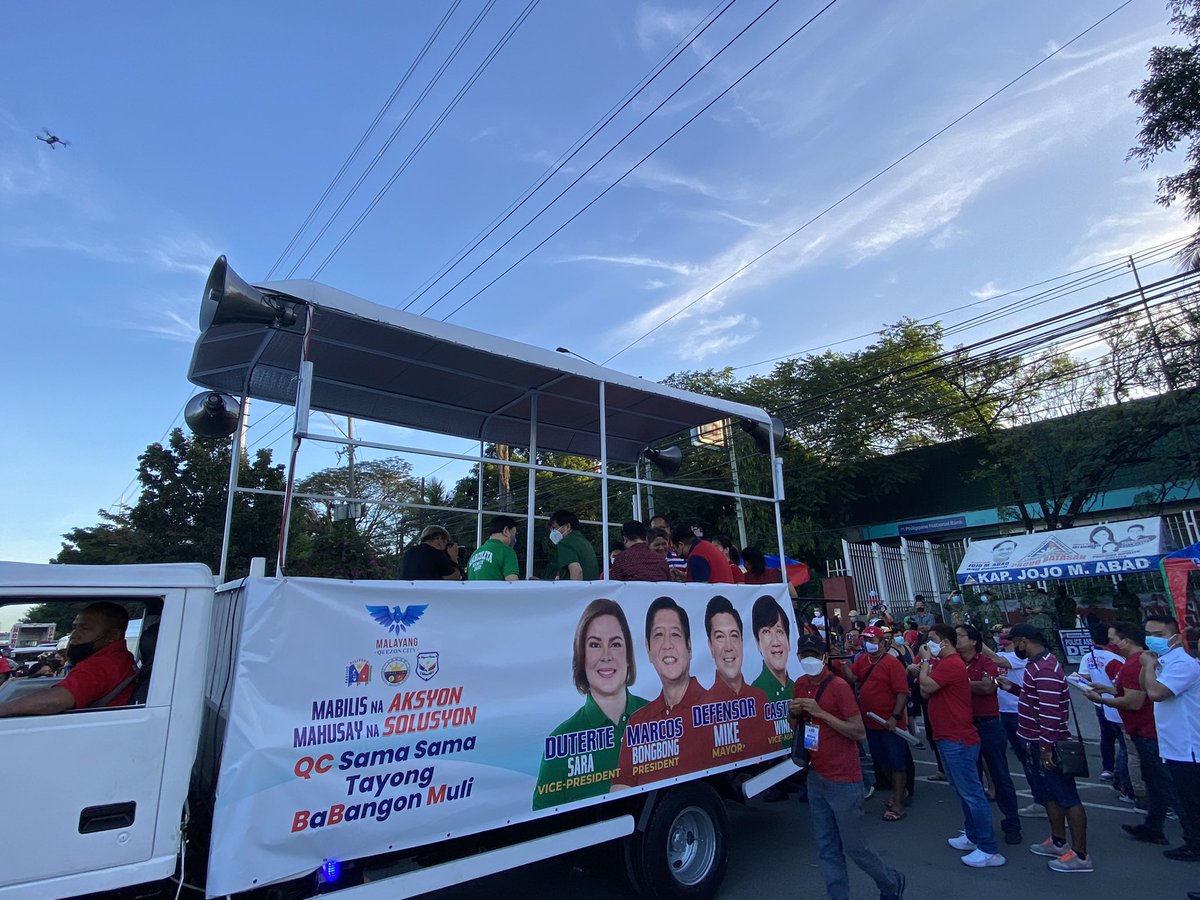 rapplerdotcom's tweet photo. Supporters of Bongbong Marcos and Sara Duterte converge in front of COA and anti-graft court Sandiganbayan for a QC caravan. It is also a local elections caravan for mayoral candidate Mike Defensor. Senatorial candidates Larry Gadon and Rodante Marcoleta here. | via @lianbuan https://t.co/2GvF89pG9L