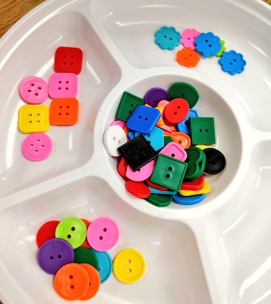 Kindergarten students have been working on sorting. Today students were asked, "How many ways can we sort these buttons?"