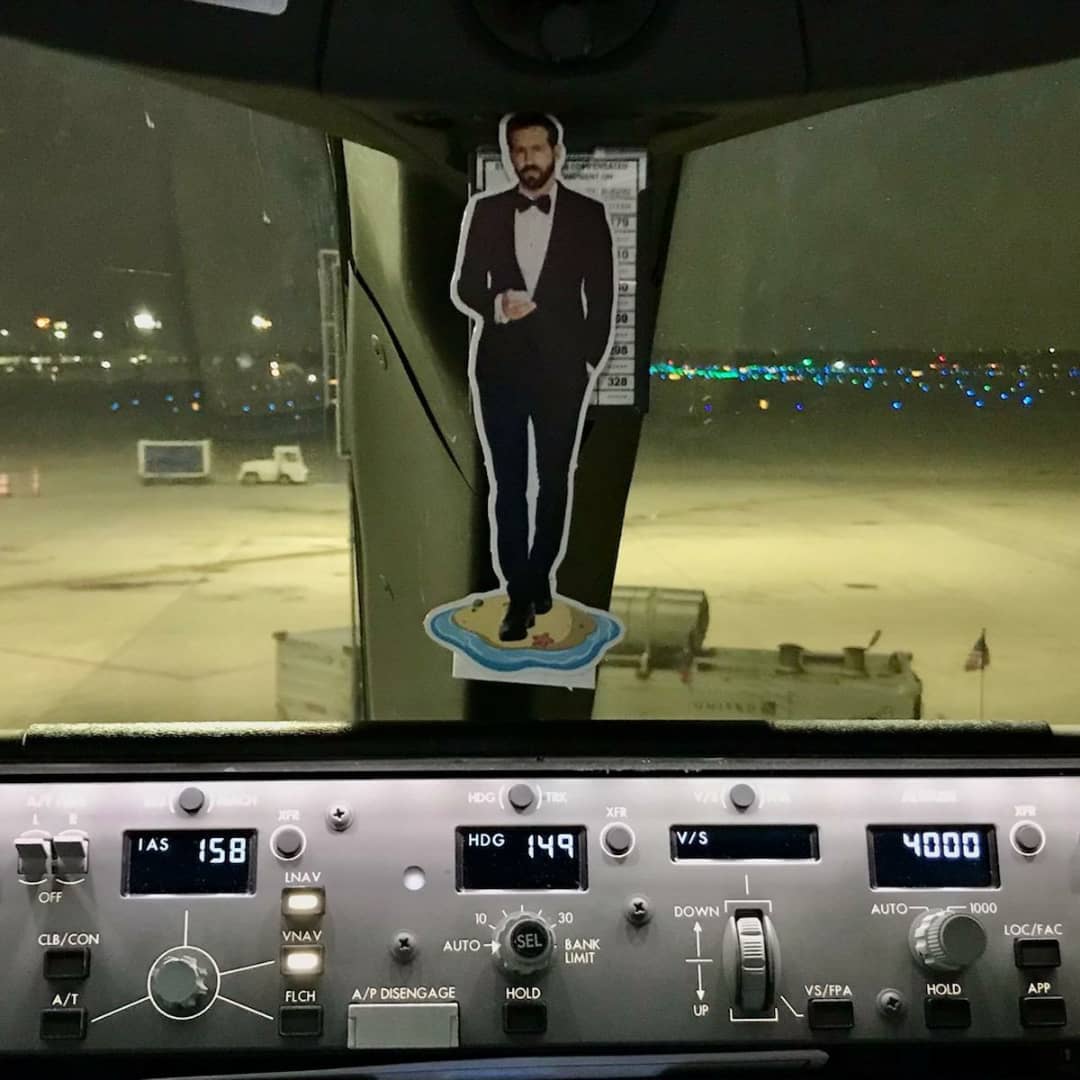 AnecdotAli's tweet photo. @VancityReynolds Ryan Reynolds sent a holiday card from @Mintmobile with a cardboard cutout of himself in a tux on a tiny island. I couldn't leave him home. He has a soul. He needs to see the world. Ryan is flying high and so are we. #MyUnitedJourney THX Jed &amp; copilot YOU RULE! https://t.co/yCCwsfEnD7