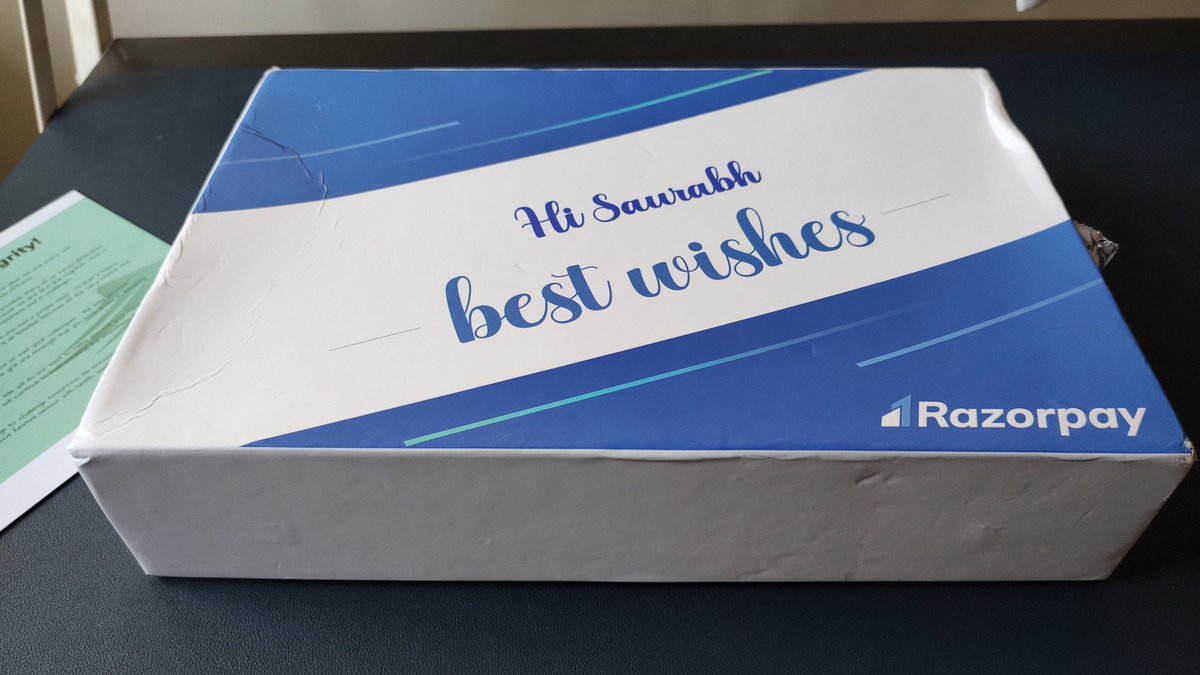 A box with cover that says Hi Saurabh best wishes razorpay