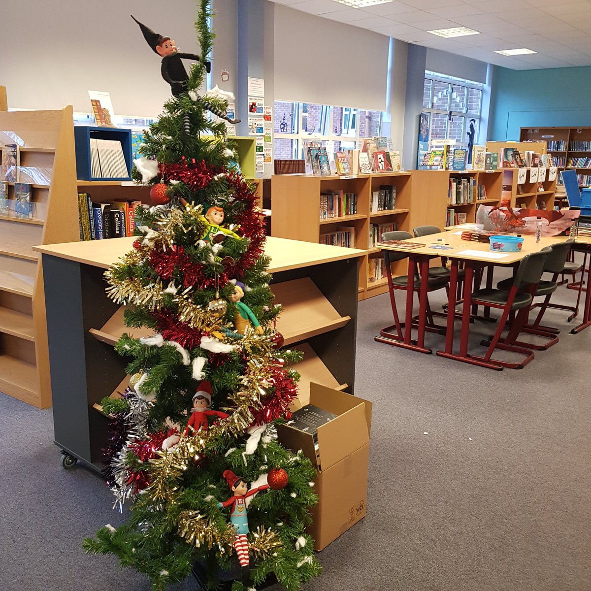 LibLourdes's tweet photo. After a failed attempt to put up the Christmas/winter #LibraryBookDisplay, the elves have infested the in progress tree (work of S4 minions). #ElfOnTheShelf #SchoolLibraries #GlasgowSchoolLibraries https://t.co/kwV3E7dRqH