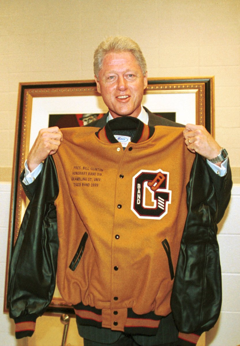 Grambling1901's tweet photo. The year was 1999. The speaker was former president Bill Clinton. The president landed in Marine One and was fitted with his hood by Coach Eddie Robinson. What a time to be alive. This year's ceremonies are coming up next week and it's your turn to make new memories. #TigerFiles https://t.co/GSNAljvFSW