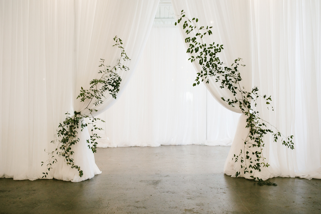 Lush greenery tie backs on beautiful draping are the definition of romantic and the perfect way to create an entrance to your reception space ✨ 
capture by @angelazionphoto
.
.
.
.
.
#katelynpinnerstudio #spring #richardphotolab #contax645 #portra400  #dsinspiration  #floraldes