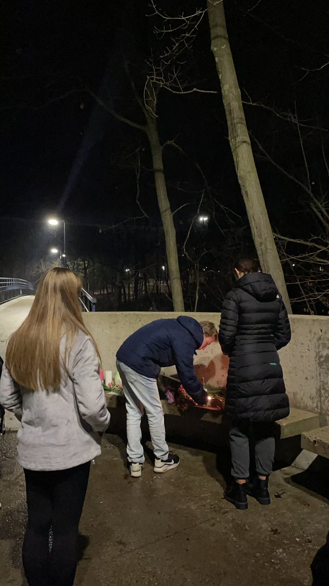 A small group of students is gathered at the little Mac bridge to light candles and create a small memorial following Mantella’s announcement #gvsu #allendale