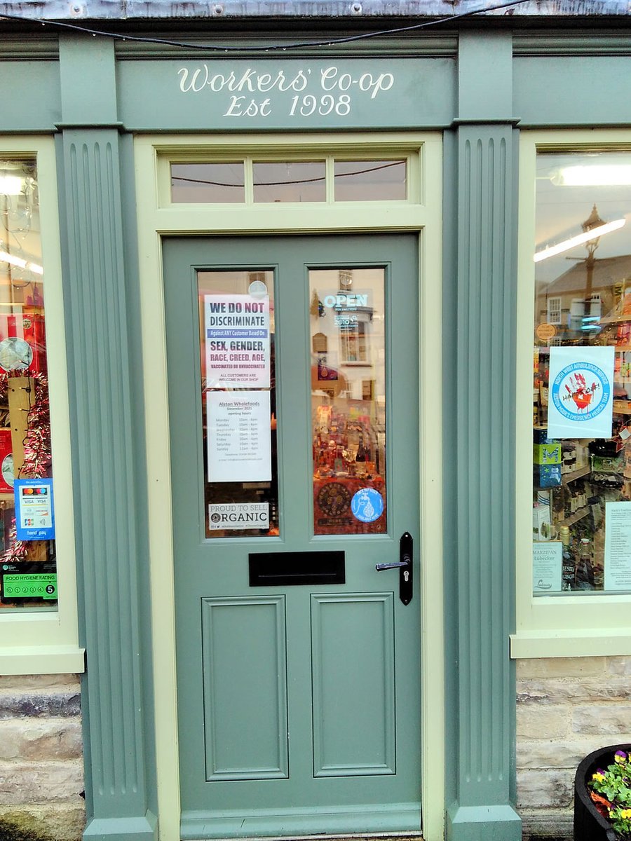 Alston Wholefoods doorway displaying  the We Do Not Discriminate poster