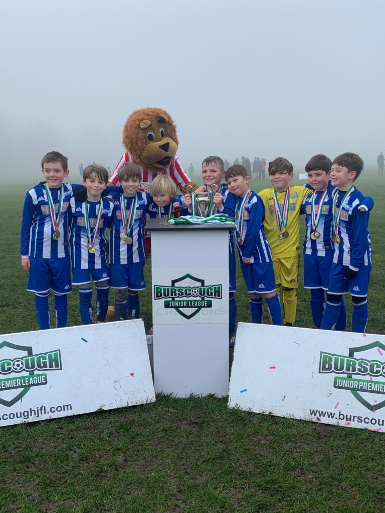 benpaglia's tweet photo. After 2 years of real struggle we won the first comp of the 21/22 season in @BurscoughJfl can't put into words what this means. Huge thanks to Raff and the team @TQSports for transforming our team and building their confidence. 10 league games played 0 loses. #grassrootsfootball https://t.co/iwJ8Sj9dV8