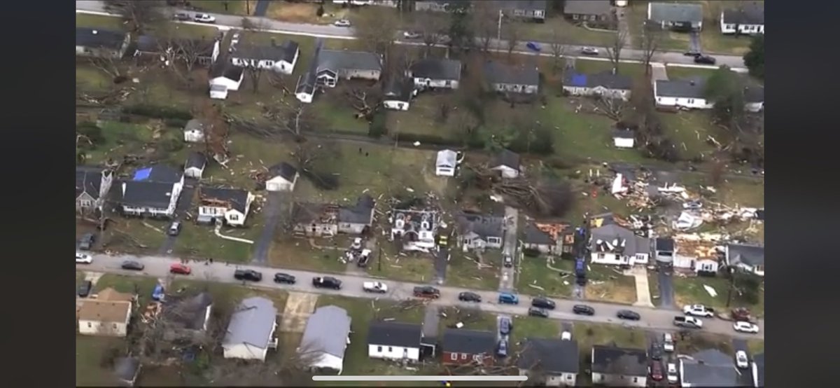 ColeClaybourn's tweet image. Aerial footage from my neighborhood. The green house in the top left in the red circle is ours. Just so much devastation around us.