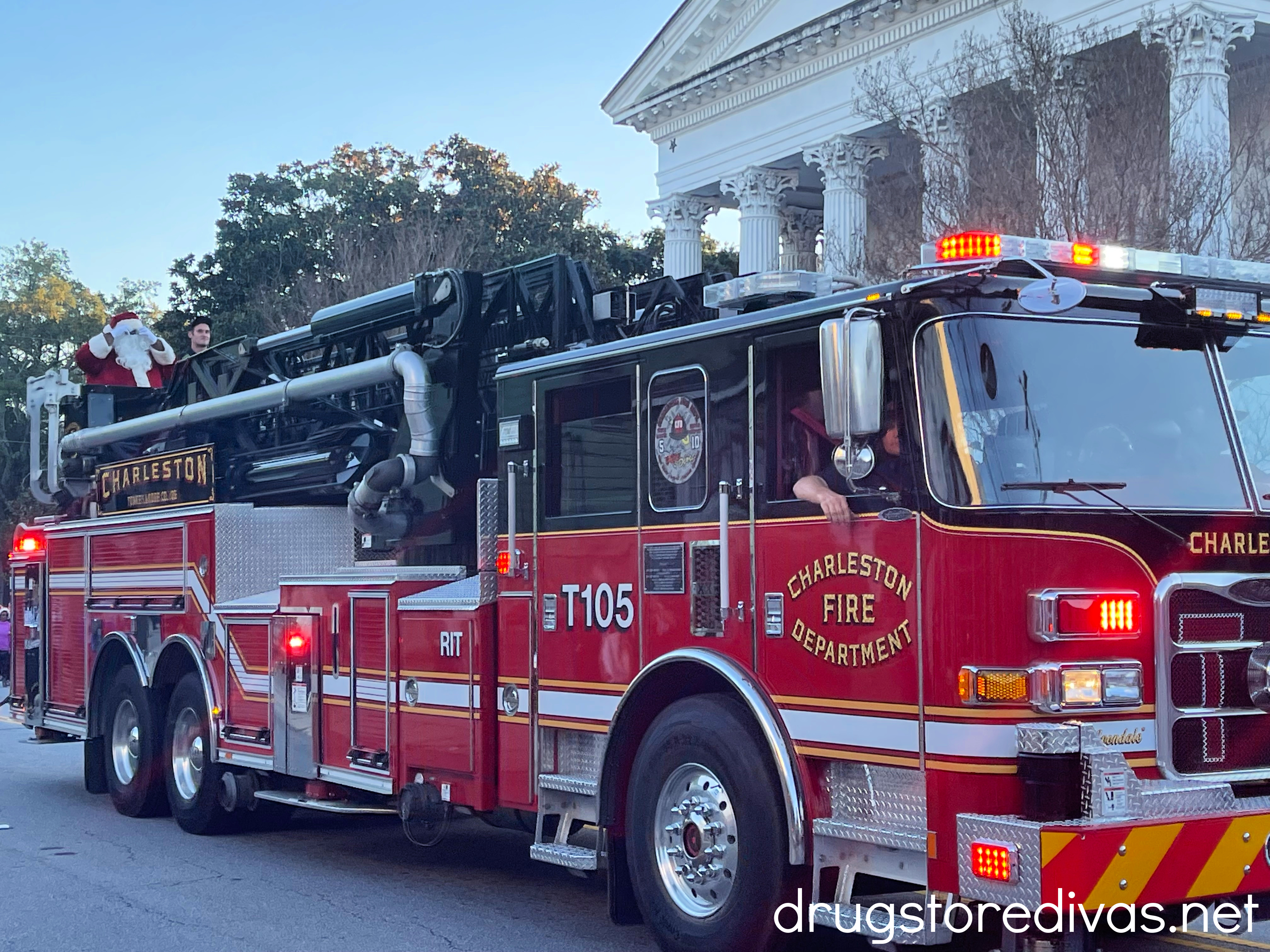 Santa waving from the back of a Charleston Fire Department fire truck.