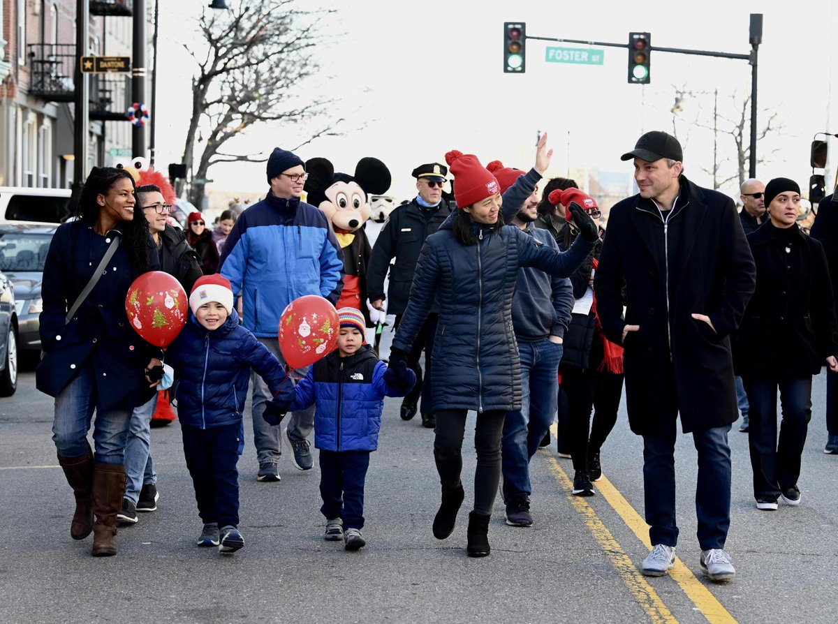 Michelle walks in a parade with her family and Boston leaders.