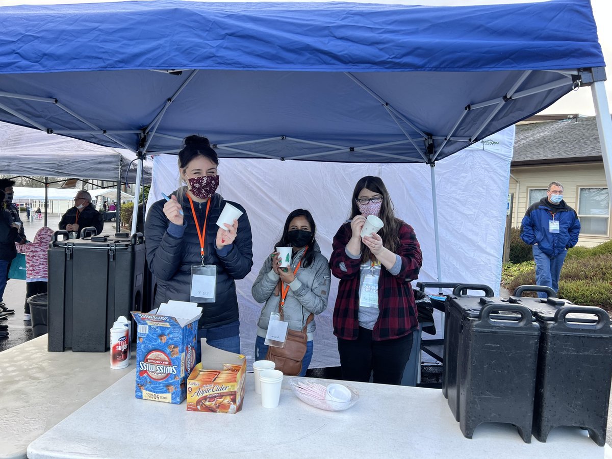 Parkland Literacy Center staff working the community event Winterfest! Serving hot cocoa while families receive community resources, gifts, and of course Santa!