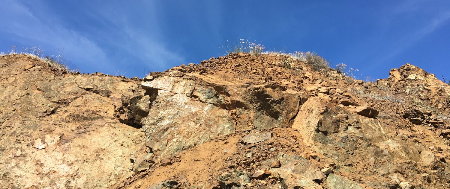 A rocky outcrop against a soft blue sky