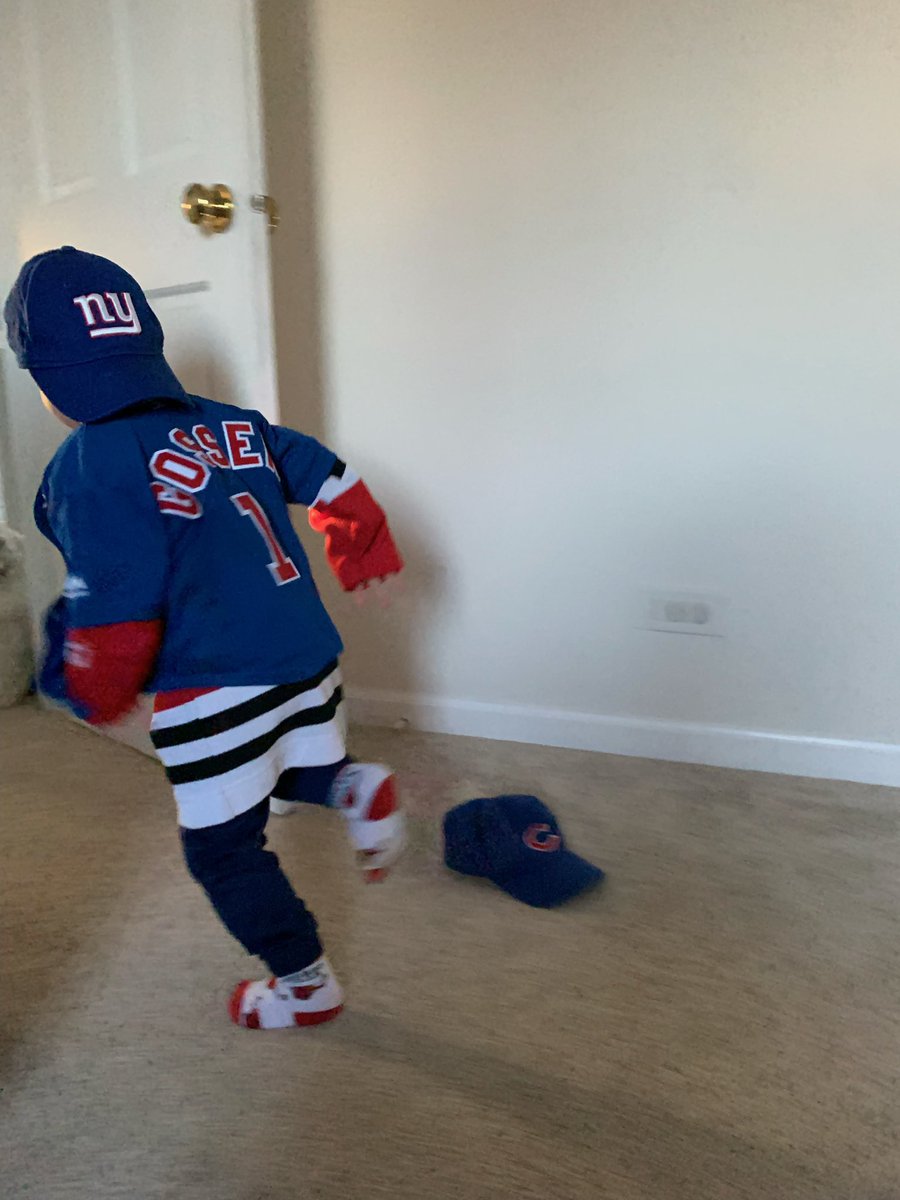 My nephew is wearing Bulls socks, a Cubs jersey (over a Blackhawks jersey) and a Giants hat. Also pictured: a discarded Cubs hat.