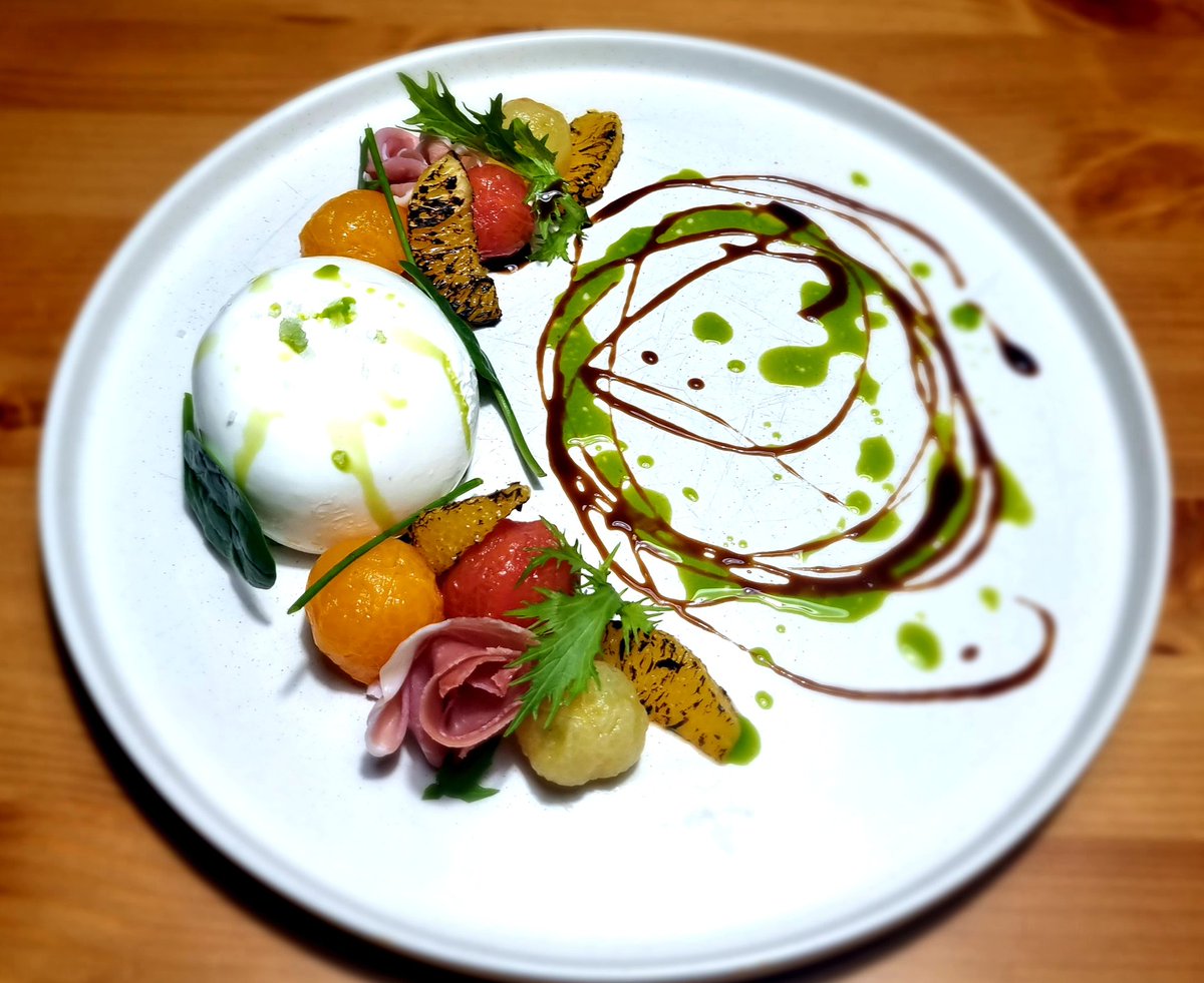 Burrata with heritage tomatoes, prosciutto and burnt orange.
