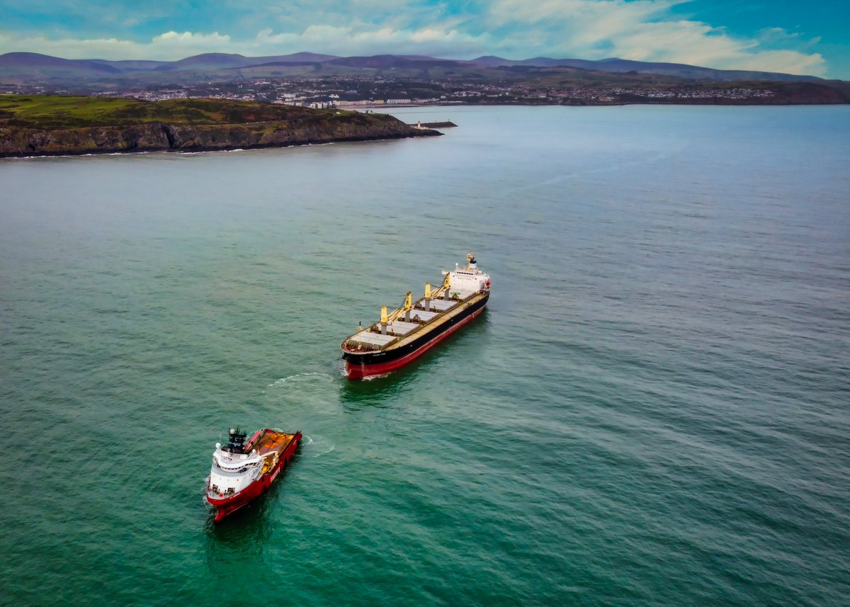 ExploringIsle's tweet image. The bulk carrier Hayama Star heading out of Manx waters earlier today assisted by K.J. Gardner after suffering an engine failure last week #IsleOfMan