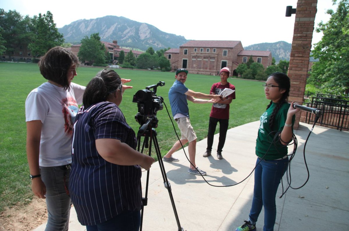 A Lens on Climate Change film mentor is demonstrating to students how to use light when filming outdoors. 
