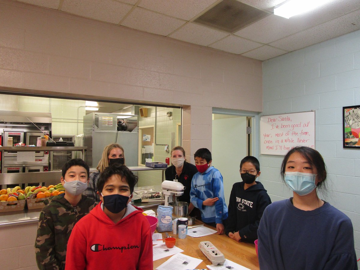 Mrs. Liz Richards and Ms.Stacy Watkins help students with English reading skills by reading directions and using standard measurement while making cookies.