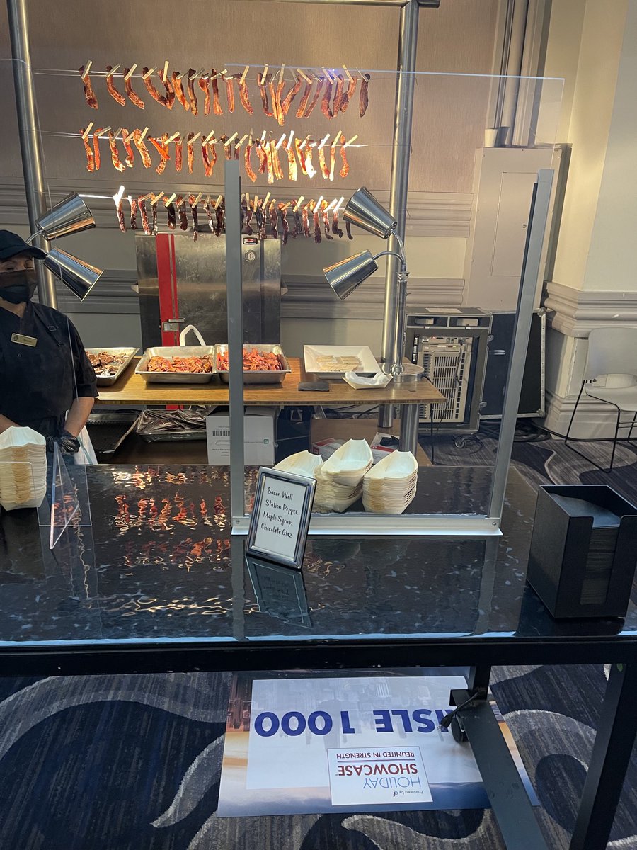 The greatest concept for the trade show floor: A bacon wall providing a rasher of bacon including one that is chocolate covered at Association Forum Holiday Showcase at Hilton Chicago.