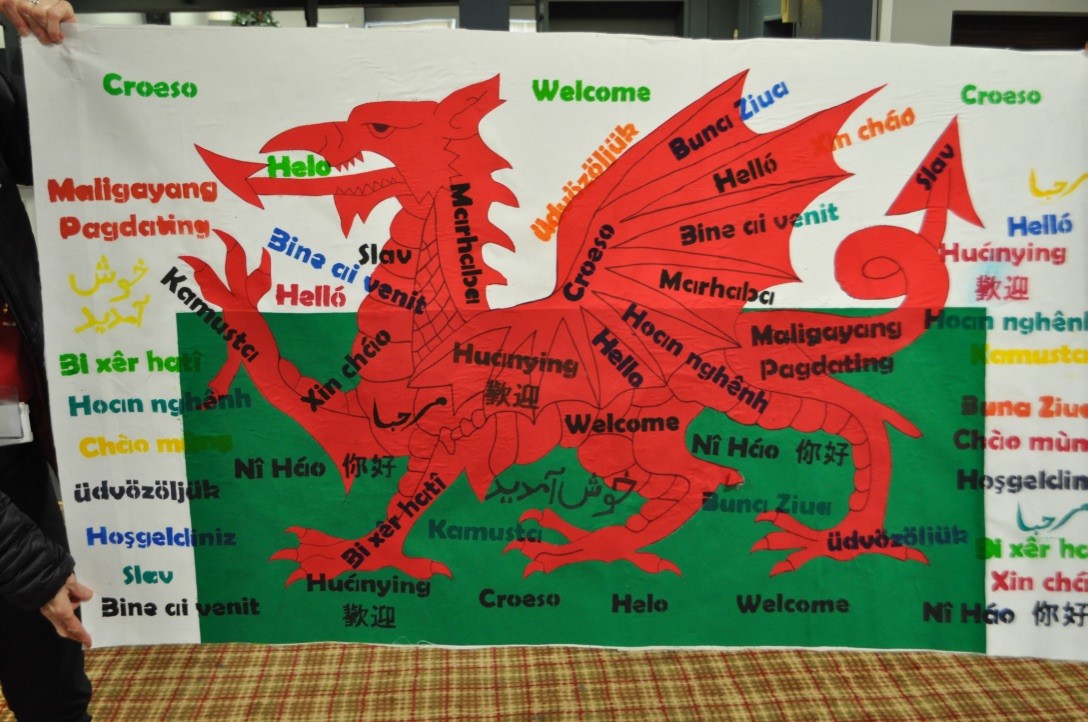DLLCelfArts's tweet photo. English as an Additional Language pupils and parents @YsgolEmmanuel  have been working with artist @FakhraRichards1  to create this stunning banner for their school, displaying the word Welcome in the 10 languages that are spoken at the school #CommunityCohesion https://t.co/uzK1YPWJd9