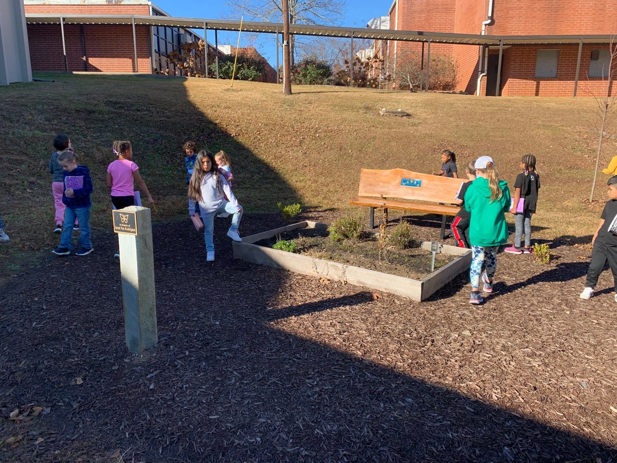 2nd graders imagined where they should add new features to our pollinator garden this month.